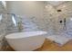 Modern bathroom showcases a freestanding tub and a walk-in shower at 553 Somersby Dr, Dallas, GA 30157