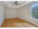 Bright bedroom boasts hardwood floors, recessed lighting, and a tray ceiling at 553 Somersby Dr, Dallas, GA 30157