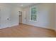 Bright bedroom features hardwood floors, a large window, and trim at 553 Somersby Dr, Dallas, GA 30157