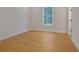 Bright bedroom features hardwood floors, a large window, and trim at 553 Somersby Dr, Dallas, GA 30157