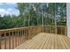 Wood deck overlooking a grassy yard and wooded area, perfect for outdoor relaxation and entertaining at 553 Somersby Dr, Dallas, GA 30157