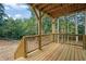 Large wood deck featuring a wooden railing, stairs to the yard, and overhead support structure at 553 Somersby Dr, Dallas, GA 30157