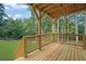 Large wood deck featuring a wooden railing, stairs to the yard, and overhead support structure at 553 Somersby Dr, Dallas, GA 30157