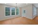 Bright dining room with lots of natural light from large windows and modern light fixture at 553 Somersby Dr, Dallas, GA 30157
