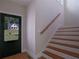 Bright entryway featuring hardwood stairs with wooden handrail and view of the outdoors at 553 Somersby Dr, Dallas, GA 30157