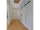 Hallway with modern sliding barn doors and skylight at 553 Somersby Dr, Dallas, GA 30157