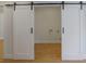Hallway with sliding barn doors leading to laundry room at 553 Somersby Dr, Dallas, GA 30157