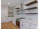 Modern kitchen features stainless steel appliances, white cabinets, tile backsplash, and stylish open shelving at 553 Somersby Dr, Dallas, GA 30157