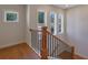 Well-lit staircase featuring wood and wrought iron accents at 553 Somersby Dr, Dallas, GA 30157