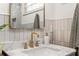 Updated bathroom features marble countertops, gold hardware, and stylish decor at 1144 Edie Se Ave, Atlanta, GA 30312