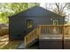 Exterior view of a dark-colored home with a wooden deck and landscaped yard at 1144 Edie Se Ave, Atlanta, GA 30312