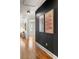 Hallway featuring modern art, hardwood floors, and neutral tones at 1144 Edie Se Ave, Atlanta, GA 30312