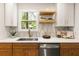 Bright kitchen featuring white cabinets, wood accents, quartz countertops, and stainless steel appliances at 1144 Edie Se Ave, Atlanta, GA 30312