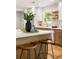 Stylish kitchen island with seating, quartz countertop, modern appliances and warm wood flooring at 1144 Edie Se Ave, Atlanta, GA 30312