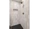 Modern bathroom shower features vertical tile, rainfall showerhead, and built-in niche at 1144 Edie Se Ave, Atlanta, GA 30312