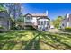 Green backyard featuring a view of the home, complete with a spacious deck and lush landscaping at 1420 Midland Way, Lawrenceville, GA 30043