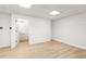 Finished basement area with hardwood style floors, ceiling lights, and an open bathroom at 1420 Midland Way, Lawrenceville, GA 30043