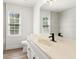 Bright bathroom featuring a large mirror, vanity, and window at 1420 Midland Way, Lawrenceville, GA 30043