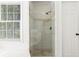 A modern glass enclosed shower featuring a tiled design at 1420 Midland Way, Lawrenceville, GA 30043
