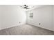 Bright bedroom features neutral carpet, white trim, ceiling fan, and natural light from a large window at 1420 Midland Way, Lawrenceville, GA 30043