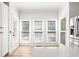 Bright breakfast nook features access to the backyard, views of the backyard, and a stainless refrigerator at 1420 Midland Way, Lawrenceville, GA 30043