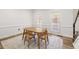 Bright dining room with hardwood floors, two windows and a table set for four at 1420 Midland Way, Lawrenceville, GA 30043
