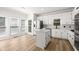 Bright kitchen features white cabinets, quartz countertops, stainless steel appliances, and an island at 1420 Midland Way, Lawrenceville, GA 30043