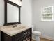 Elegant powder room featuring dark wood vanity with marble countertop, undermount sink, and modern faucet at 1420 Midland Way, Lawrenceville, GA 30043