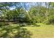 Spacious backyard with mature trees creates a private and serene setting for outdoor activities at 2383 Baker Nw Rd, Atlanta, GA 30318