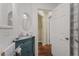 Bathroom with granite vanity, lighting, and access to hallway at 2383 Baker Nw Rd, Atlanta, GA 30318