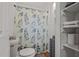 Clean bathroom features toilet, shelves, and shower with curtain at 2383 Baker Nw Rd, Atlanta, GA 30318