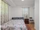 Cozy bedroom features hardwood floors, patterned curtains, and a comfortable bed at 2383 Baker Nw Rd, Atlanta, GA 30318