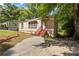 Charming tan home with a concrete drive, complemented by mature trees at 2383 Baker Nw Rd, Atlanta, GA 30318