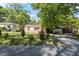 Charming tan home with a well maintained lawn and mature trees at 2383 Baker Nw Rd, Atlanta, GA 30318