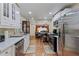 Open concept kitchen with stainless steel appliances flowing into living area at 2383 Baker Nw Rd, Atlanta, GA 30318