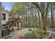 Backyard with patio, stone fire pit and surrounding trees at 4284 Windy Gap Nw Ct, Kennesaw, GA 30144