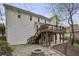 Large backyard with stone patio, fire pit, deck and lush greenery at 4284 Windy Gap Nw Ct, Kennesaw, GA 30144