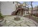 Backyard with stone patio, fire pit, deck and lush surroundings at 4284 Windy Gap Nw Ct, Kennesaw, GA 30144