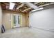 Unfinished basement space with double doors leading outside, and a blank wall ready for customization at 4284 Windy Gap Nw Ct, Kennesaw, GA 30144