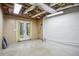 Partially finished basement with exposed ceiling, concrete flooring and access to outdoors at 4284 Windy Gap Nw Ct, Kennesaw, GA 30144