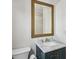 Modern bathroom features a marble countertop and a gold-trimmed mirror at 4284 Windy Gap Nw Ct, Kennesaw, GA 30144