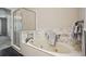 Modern bathroom featuring a soaking tub with marble backsplash, glass shower, and neutral tones at 4284 Windy Gap Nw Ct, Kennesaw, GA 30144