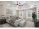 Serene bedroom featuring a tray ceiling, a ceiling fan, soft colors, and natural light from two windows at 4284 Windy Gap Nw Ct, Kennesaw, GA 30144