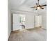 Bedroom with attached bath featuring tray ceiling and neutral color carpet at 4284 Windy Gap Nw Ct, Kennesaw, GA 30144