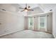 Spacious bedroom with tray ceiling, carpet, ceiling fan and natural light from two windows with curtains at 4284 Windy Gap Nw Ct, Kennesaw, GA 30144