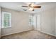 Inviting bedroom with two bright windows, neutral walls, carpet, and a ceiling fan, promoting relaxation at 4284 Windy Gap Nw Ct, Kennesaw, GA 30144
