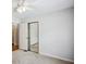 Comfortable bedroom with ceiling fan, carpet flooring, and mirrored closet, offering ample storage space at 4284 Windy Gap Nw Ct, Kennesaw, GA 30144