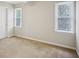 Neutral bedroom with carpeted floors, bright windows, and a ceiling fan for added comfort and style at 4284 Windy Gap Nw Ct, Kennesaw, GA 30144