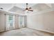 Spacious bedroom with a tray ceiling, fan and natural light at 4284 Windy Gap Nw Ct, Kennesaw, GA 30144