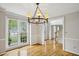 Formal dining room with large windows offering great views and a stylish chandelier at 4284 Windy Gap Nw Ct, Kennesaw, GA 30144